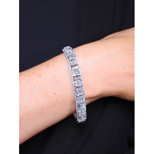 47 - A Diamond Bracelet,

each panel centrally set with vari-cut diamonds including shield baguette marqu... 