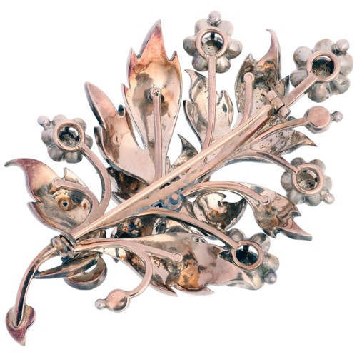 78 - A Diamond Floral Spray Brooch, 

realistically chased and set with rose-cut diamonds, the centre hav... 