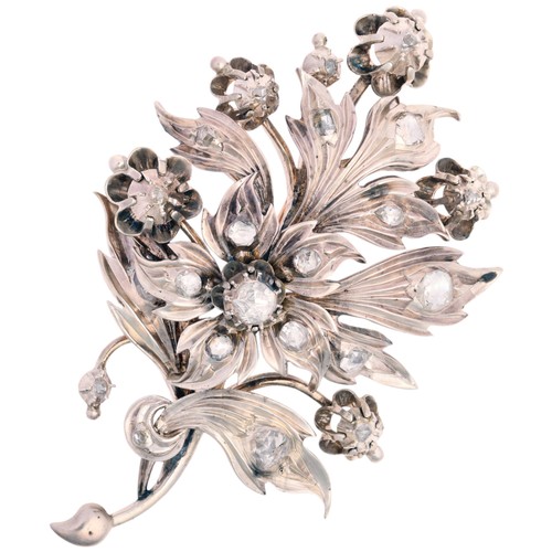 78 - A Diamond Floral Spray Brooch, 

realistically chased and set with rose-cut diamonds, the centre hav... 