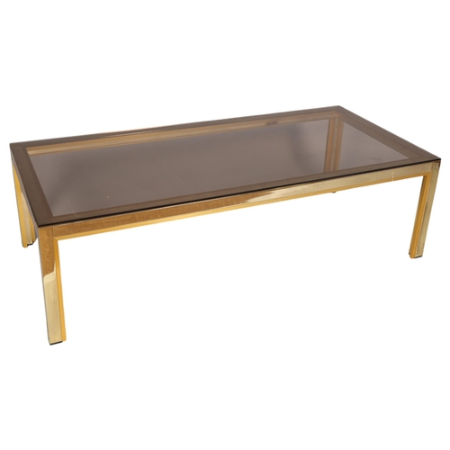 63 - A 1970s' Renato Zevy, Italian coffee table, with smoked glass top on brass/gilt frame, top 130 x 60c... 