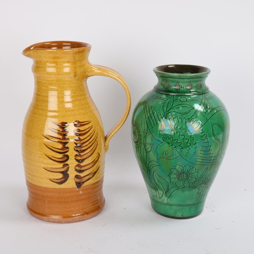 180 - A slip glazed earthenware studio pottery jug and a green slip glaze earthenware  vase with sgraffito... 