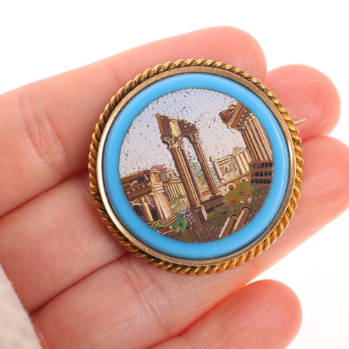 1243 - An Antique Italian Grand Tour 14ct gold micro-mosaic 'Roman Ruins' panel brooch, circa 1850, the rou... 