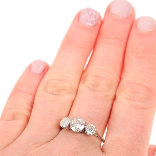 1247 - An 18ct white gold three stone diamond ring, claw set with round brilliant and transitional-cut diam... 