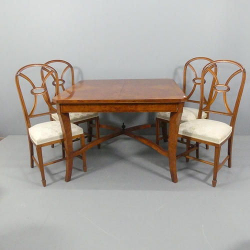 2173 - A modern burr-walnut veneered and ebony strung draw-leaf dining table, with x-shaped stretcher and f... 