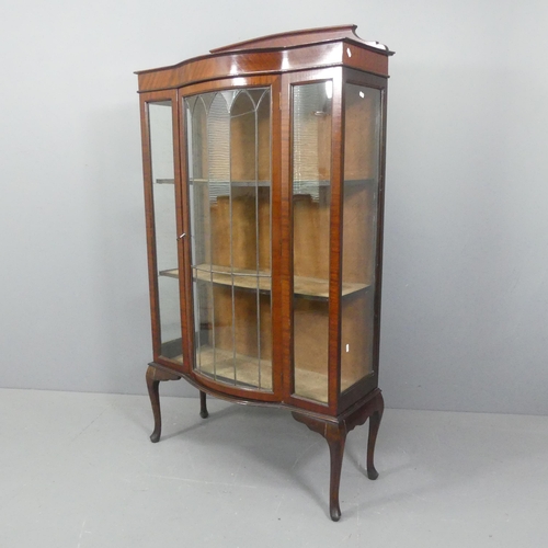 2182 - A 1930s mahogany display cabinet, with raised back, lattice glazed door and raised on cabriole legs.... 