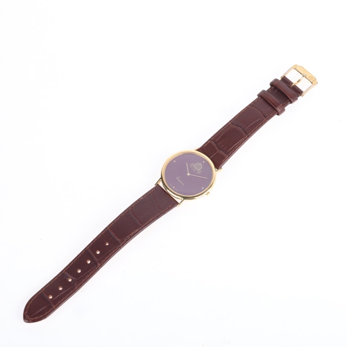 1021 - KUTCHINSKY - an 18ct gold 'Saudi Arabia Emblem' quartz wristwatch, maroon dial with gilt quarterly d... 