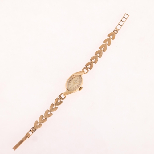 1033 - OMEGA - a lady's Vintage 14ct gold mechanical bracelet watch, circa 1960s, textured champagne dial w... 