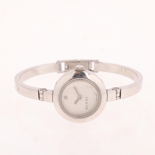 1035 - GUCCI - a lady's stainless steel 105 Series quartz bangle watch, silvered floral dial with diamond h... 