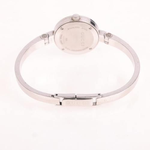 1035 - GUCCI - a lady's stainless steel 105 Series quartz bangle watch, silvered floral dial with diamond h... 