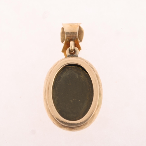 1103 - An Antique Victorian 9ct gold chrysolite and opal mourning locket pendant, oval form with chased scr... 