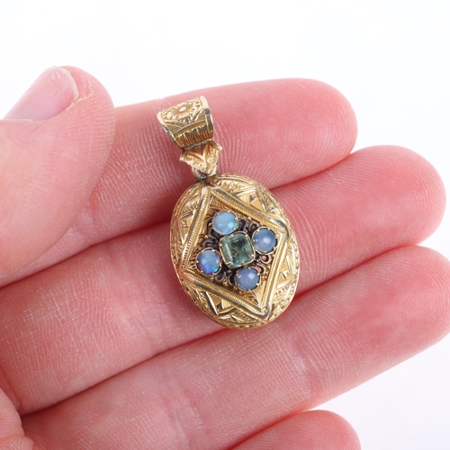 1103 - An Antique Victorian 9ct gold chrysolite and opal mourning locket pendant, oval form with chased scr... 