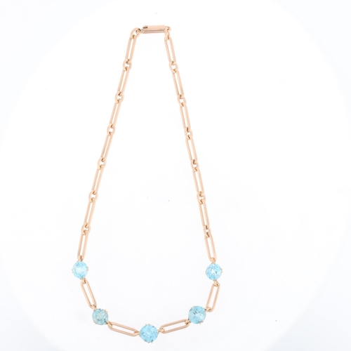 1104 - A 9ct rose gold blue zircon trombone link chain necklace, maker NCW, import hallmarks London 1978, s... 