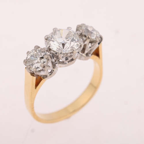 1110 - An 18ct gold three stone diamond ring, claw set with old European-cut diamonds, total diamond conten... 