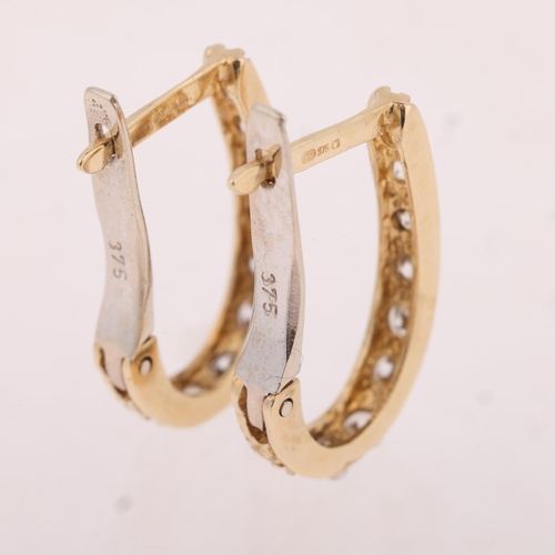 1115 - A pair of 9ct two-colour gold cubic zirconia half hoop earrings, with English lock fittings, 21.7mm,... 