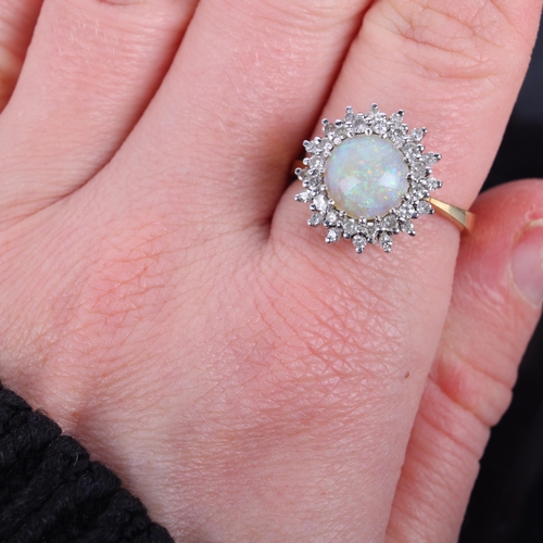 1122 - An 18ct gold opal and diamond cluster ring, maker KC, London 1975, claw set with round cabochon opal... 