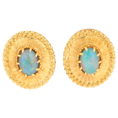 1143 - A pair of 18ct gold opal triplet stud earrings, oval form with textured decoration, claw set with ov... 