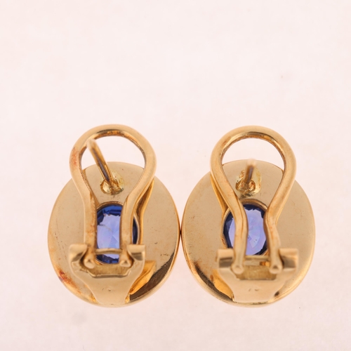 1144 - A pair of 18ct gold sapphire earrings, each rub-over set with a 0.65ct oval mixed-cut sapphire withi... 