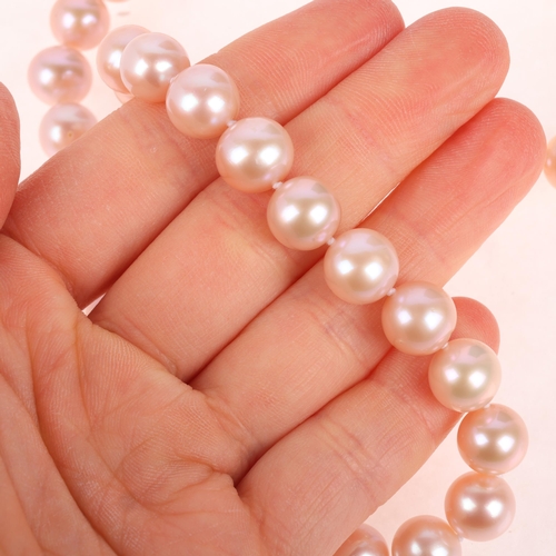 1156 - A single-strand natural pink freshwater cultured pearl necklace, set with individually knotted 9.5-1... 