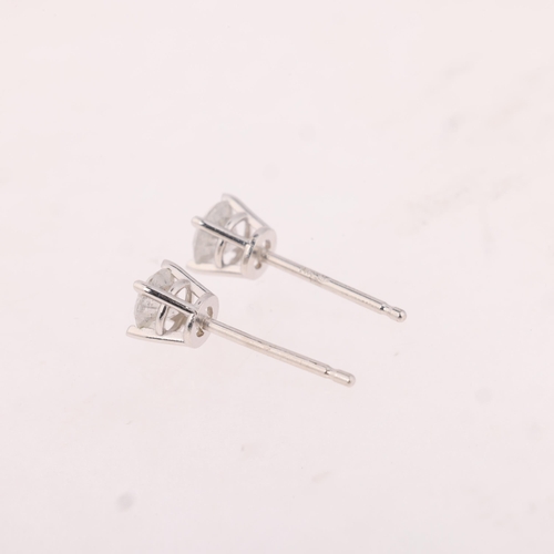 1163 - A pair of 14ct white gold 0.4ct single stone diamond stud earrings, each claw set with 0.2ct modern ... 