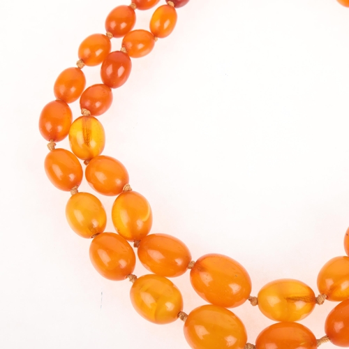 1174 - A Vintage double-strand graduated amber bead necklace, beads ranging from 18.6-9.7mm, 32cm, 45.8g