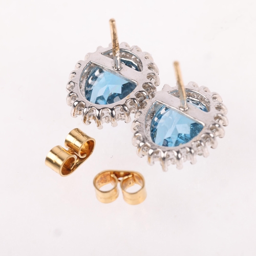 1183 - A pair of 9ct gold blue topaz and diamond cluster stud earrings, claw set with oval mixed-cut topaz ... 