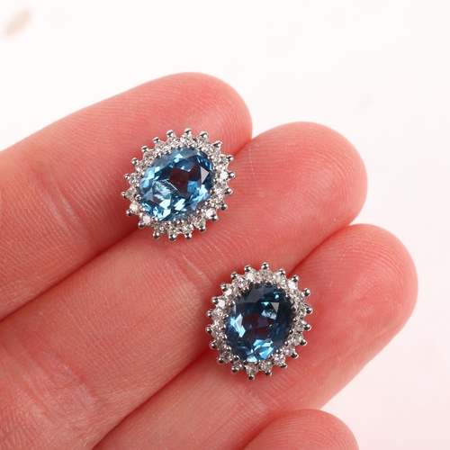 1183 - A pair of 9ct gold blue topaz and diamond cluster stud earrings, claw set with oval mixed-cut topaz ... 