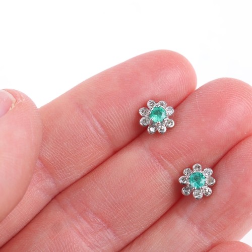 1192 - A pair of 18ct white gold emerald and diamond flowerhead cluster stud earrings, set with round-cut e... 