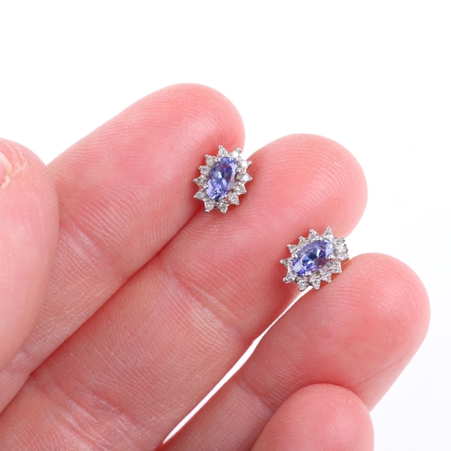 1194 - A pair of 9ct white gold tanzanite and diamond cluster stud earrings, claw set with oval mixed-cut t... 