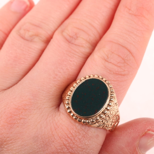 1244 - A large 9ct rose gold bloodstone signet ring, indistinct maker, London 1974, set with polished oval ... 