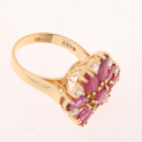 1245 - A 14ct gold ruby and diamond cluster cocktail ring, set with vari-cut rubies and modern round brilli... 