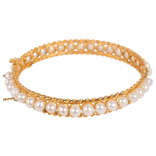 1269 - A Middle Eastern 18ct gold freshwater pearl hinged bangle, set throughout with 5mm pearls, rope twis... 