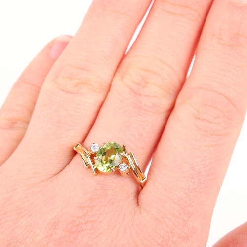 1278 - An 18ct gold three stone peridot and diamond crossover ring, set with oval mixed-cut peridot and mod... 