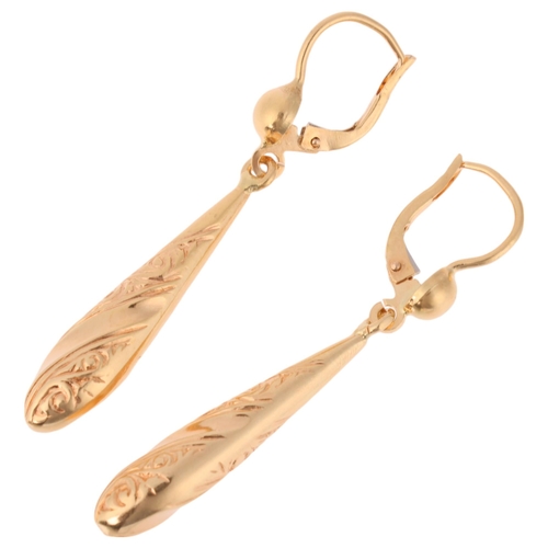 1324 - A pair of 18ct gold drop earrings, the torpedo drops with relief embossed scrollwork decoration and ... 