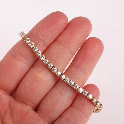 1325 - A 14ct gold cubic zirconia tennis line bracelet, 17cm, 12.8g