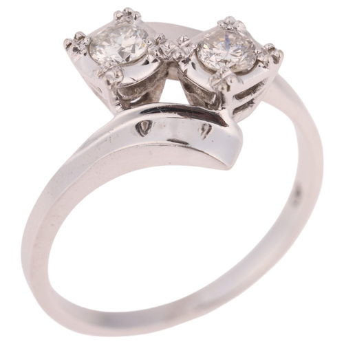 1334 - A 14ct white gold diamond crossover ring, set with modern round brilliant-cut diamonds, total diamon... 