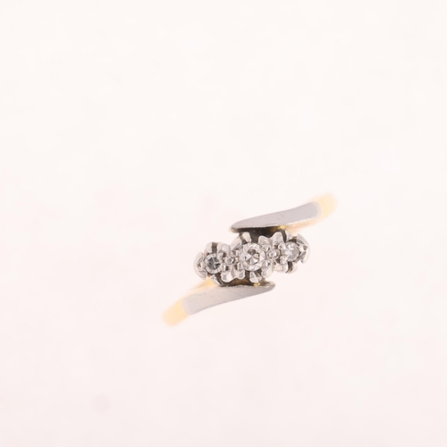 1335 - An 18ct gold three stone diamond crossover ring, platinum-topped set with round-cut diamonds, settin... 