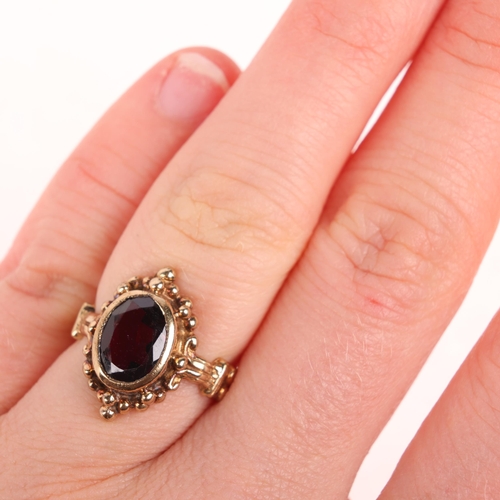 1340 - A 9ct gold single stone garnet dress ring, rub-over set with oval mixed-cut garnet, indistinct hallm... 