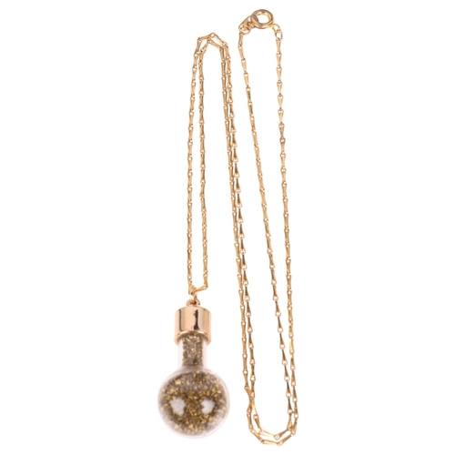 1363 - A novelty gold shavings pendant necklace, the glass tube filled with gold shavings with gold plated ... 