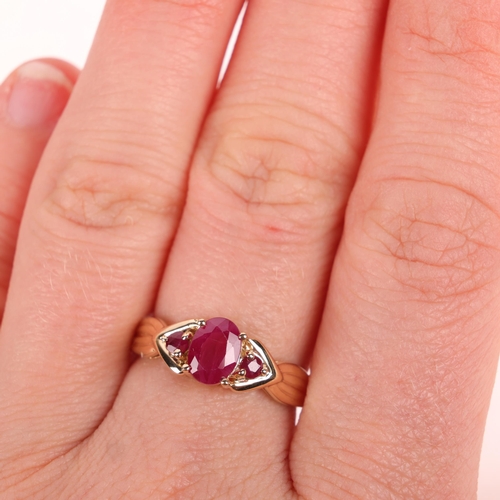 1368 - A 9ct gold three stone ruby dress ring, London 2003, set with oval and round-cut rubies, setting hei... 