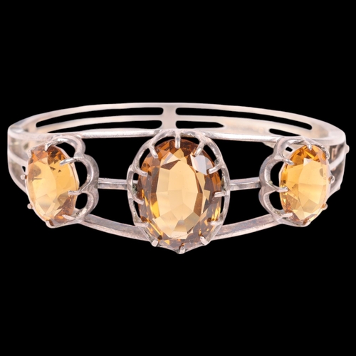 1455 - A silver citrine hinged bangle, unmarked, setting height 21.4mm, internal circumference 16cm, 30g