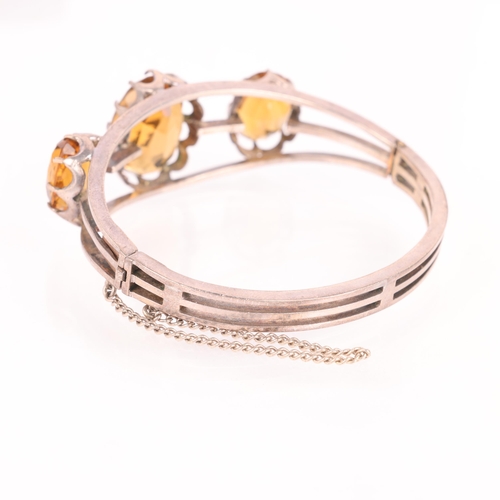 1455 - A silver citrine hinged bangle, unmarked, setting height 21.4mm, internal circumference 16cm, 30g