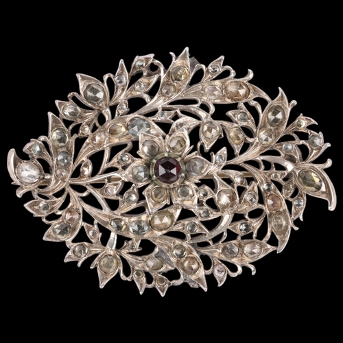 1467 - A large 19th century silver garnet and jargoon floral brooch, with engraved closed-back settings, un... 