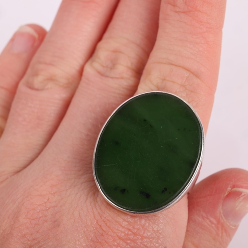 1493 - NIELS ERIK FROM - a Danish modernist sterling silver nephrite panel ring, plain form set with oval l... 