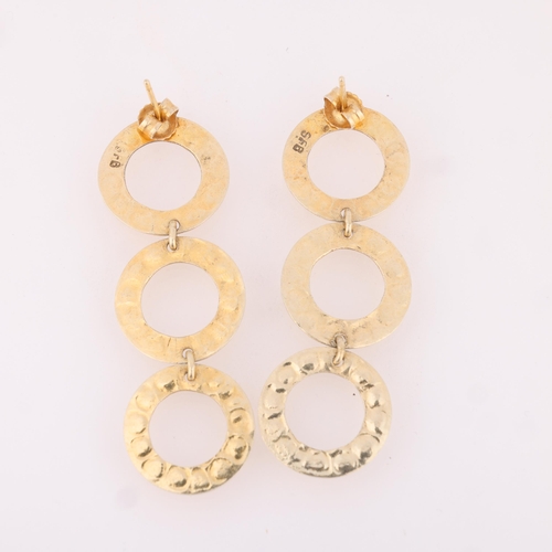 1510 - STEEN F BAKER - a pair of Danish sterling silver-gilt hoop drop stud earrings, with planished decora... 