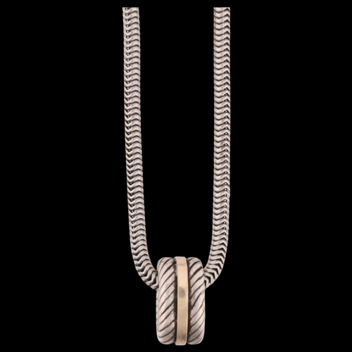 1517 - JENS JOHS AAGAARD - a Danish modernist sterling silver and silver-gilt hoop pendant necklace, on ste... 