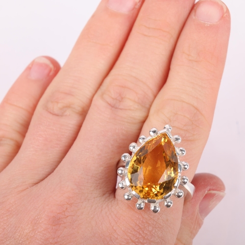 1541 - A heavy sterling silver citrine dress ring, set with pear-cut citrine, setting height 20mm, size R, ... 