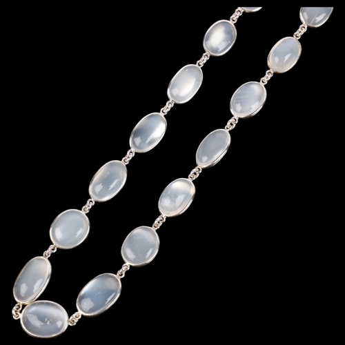 1542 - A single-strand sterling silver graduated moonstone tennis line necklace, set with oval cabochon moo... 