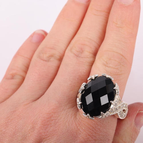 1543 - A heavy sterling silver onyx and cubic zirconia dress ring, setting height 17.4mm, size V, 14.2g