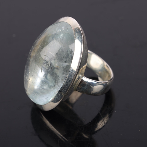 1545 - A heavy sterling silver aquamarine dress ring, set with oval cabochon aquamarine, setting height 26.... 