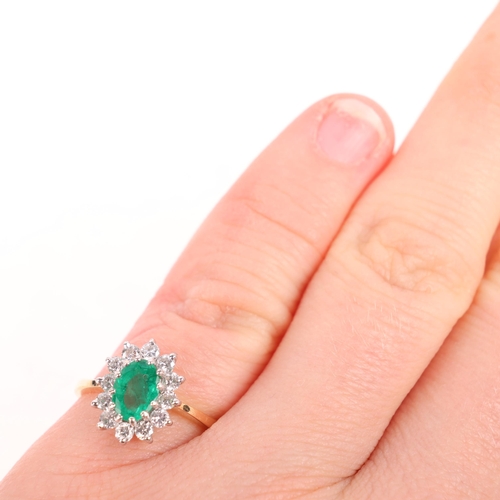 1380 - An 18ct gold emerald and diamond cluster ring, London 1989, claw set with oval mixed-cut emerald and... 